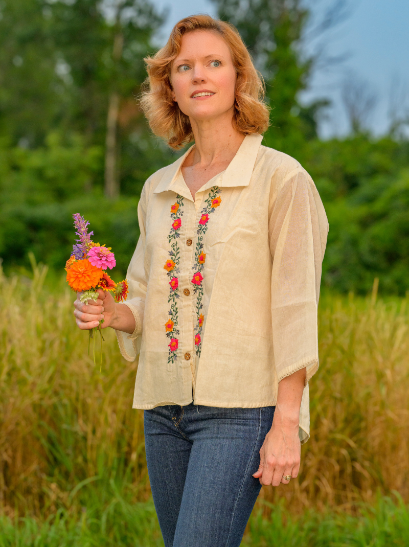Woman holding a bouquet of flowers in a field