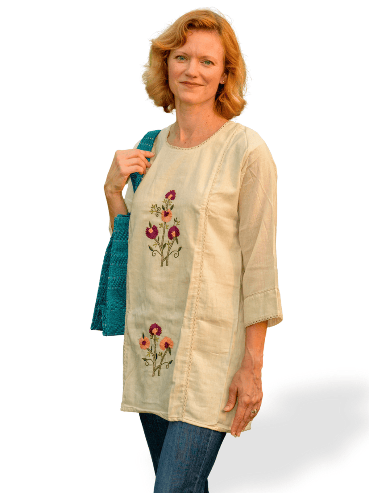 Woman wearing a beige embroidered tunic with a white background