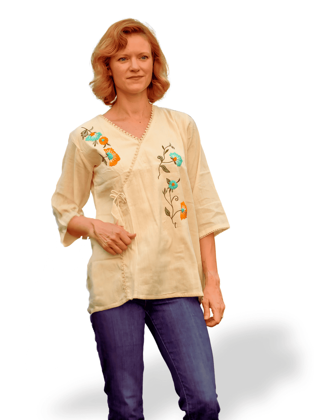 Woman wearing a beige blouse with floral embroidery on a white background
