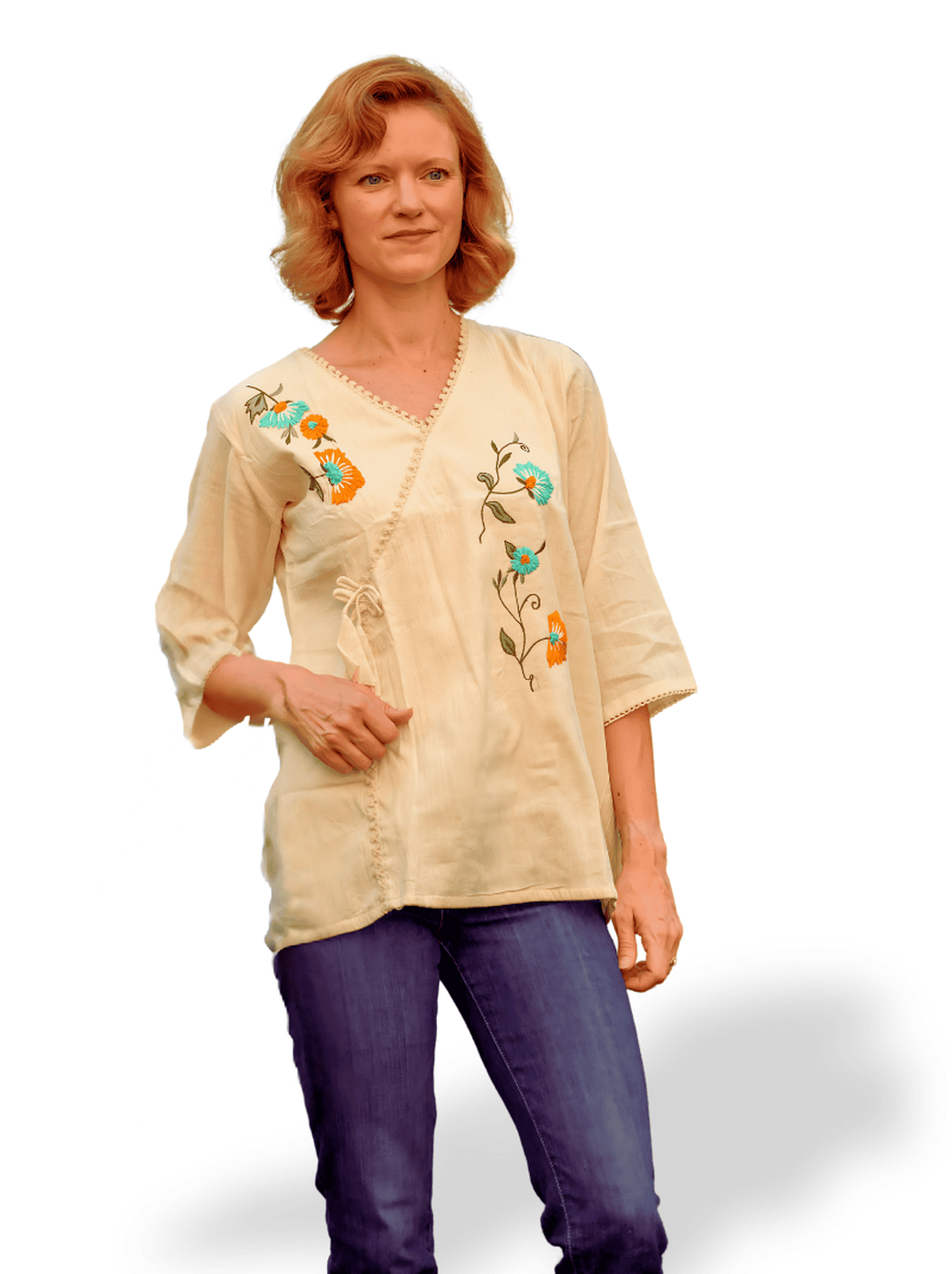 Woman wearing a beige blouse with floral embroidery on a white background